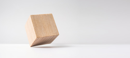 Design concept - abstract geometric real wooden cube with surreal layout on white floor background and it's not 3D render
