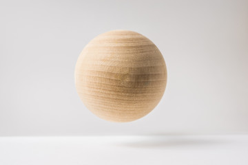 Design concept - abstract real wooden sphere with surreal layout on white surface background and...