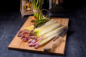 white and green asparagus on kitchen board