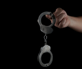 steel handcuffs of police special equipment, fetters on a black background