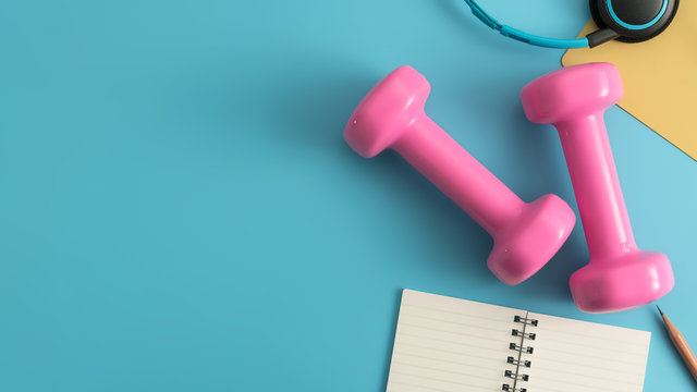 Styled stock photography of fitness equipment dumbbells notepad pencil and earphone on blue background. Flat lay.