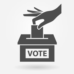 Voting icon concept. Hand putting voting paper into the ballot box