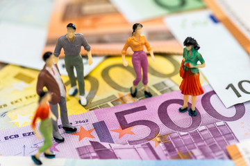 financial deal concept - miniature people on euro banknotes