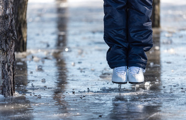 Female ice skates on the ice in the park