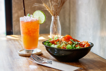 Salad with fruit punch drink.