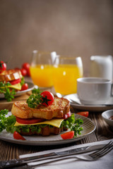 Sandwich of croutons with coffee and orange juice.