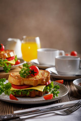Sandwich of croutons with coffee and orange juice.