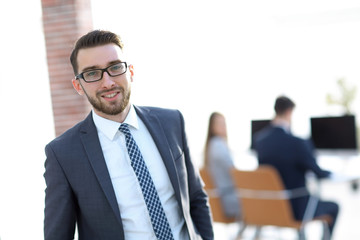 Fototapeta premium successful businessman on background of office