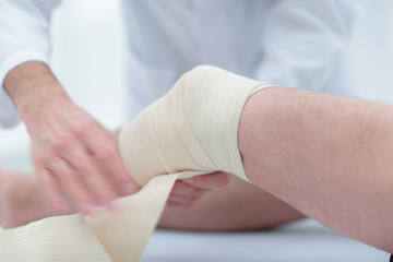 closeup. doctor bandaging a patient's leg