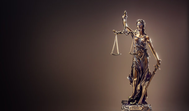 Statute of Justice. Bronze statue Lady Justice holding scales and sword