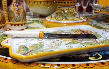 Knife lies on a beautiful ceramic tray on the table.