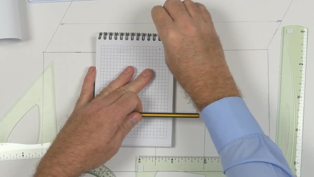 Top View with Architect Table Hands Erase a Draw and Use a Pencil Sharpener