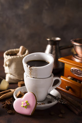 Coffee cup and beans on a dark background.