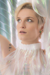 Portrait of beautiful young woman in shimmering transparent cape.