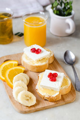 A sandwich with butter, honey and soft cheese. The concept of a healthy and tasty breakfast.