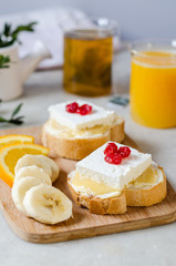 A sandwich with butter, honey and soft cheese. The concept of a healthy and tasty breakfast.