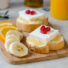 A sandwich with butter, honey and soft cheese. The concept of a healthy and tasty breakfast.