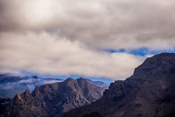 mountain view with clouds in tenerife. dry rocks