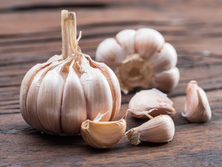 Garlic bulb and garlic cloves on the wooden table.
