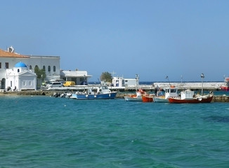 Fototapeta premium White Colored with Blue Cupola Greek Orthodox Church at the Old Port of Mykonos, Greece