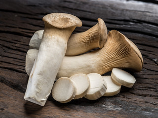King oyster mushrooms on the wooden background.
