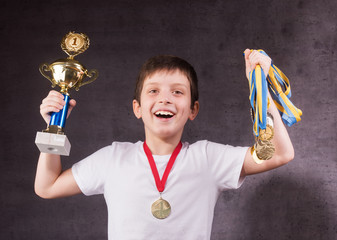 Little boy celebrates his golden trophy © rodjulian