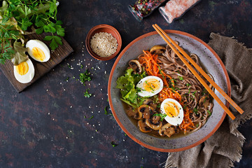 Japanese miso ramen noodles with eggs, carrot and mushrooms. Soup delicious food. Flat lay. Top view