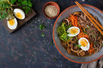 Japanese miso ramen noodles with eggs, carrot and mushrooms. Soup delicious food. Flat lay. Top view