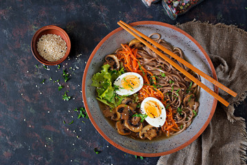 Japanese miso ramen noodles with eggs, carrot and mushrooms. Soup delicious food. Flat lay. Top view