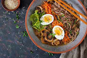 Japanese miso ramen noodles with eggs, carrot and mushrooms. Soup delicious food. Flat lay. Top view