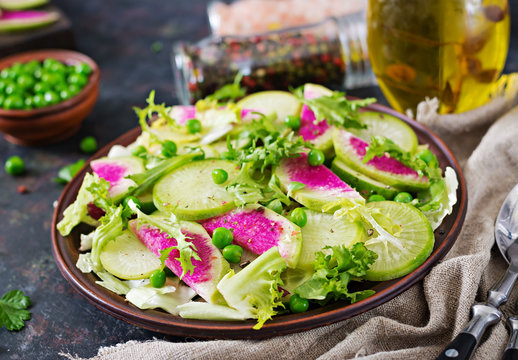 Salad from radish, cucumber and lettuce leaves. Vegan food. Dietary menu.