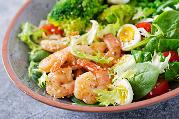 Healthy salad plate. Fresh seafood recipe. Grilled shrimps and fresh vegetable salad, egg and broccoli. Grilled prawns. Healthy food