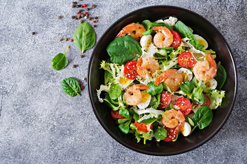 Healthy salad plate. Fresh seafood recipe. Grilled shrimps and fresh vegetable salad and egg....