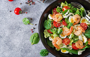 Healthy salad plate. Fresh seafood recipe. Grilled shrimps and fresh vegetable salad and egg. Grilled prawns. Healthy food. Flat lay. Top view