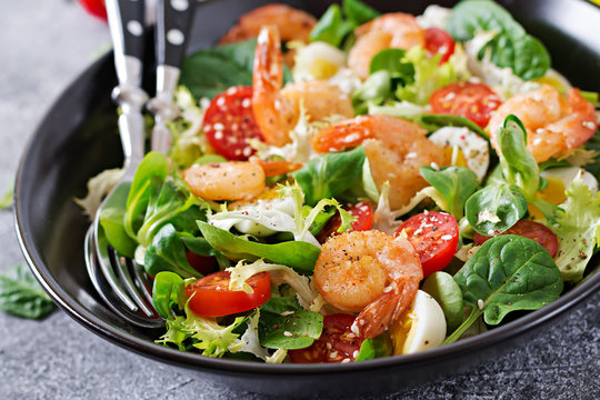 Healthy salad plate. Fresh seafood recipe. Grilled shrimps and fresh vegetable salad and egg. Grilled prawns. Healthy food.