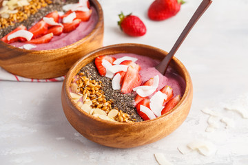Fototapeta na wymiar Vegan breakfast concept. Strawberry smoothie bowl with almonds, chia, sprouts and coconut.