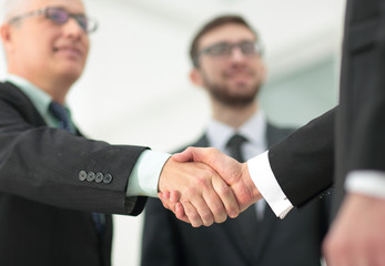 closeup handshake proven business partners