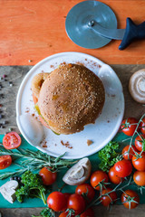 A delicious hamburger for lunch in a cafe. People eat a hamburger