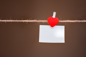 Red heart for lovers of valentine's day on a rope with a place for inscriptions