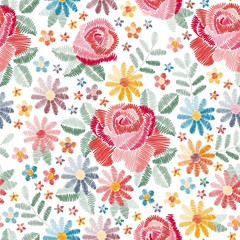 Embroidery seamless pattern with beautiful colorful flowers on white background. Fancywork in vintage style. Fashion design. Vector illustration.