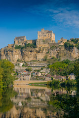 Fototapeta na wymiar Beautiful ancient castle in France. The best view of the royal castle and the river Dordogne. Beautiful village and fortress. filming 