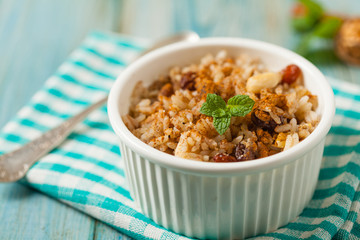Traditional, mexican baked sweet rice, with almonds, raisins and walnuts.