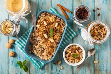 Traditional, mexican baked sweet rice, with almonds, raisins and walnuts.