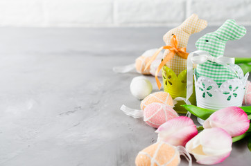 Easter composition with bunnies, eggs and tulips.