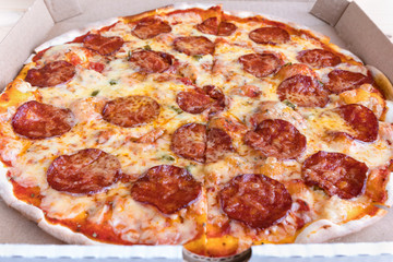 Pizza Pepperoni in a cardboard box. Pizza delivery