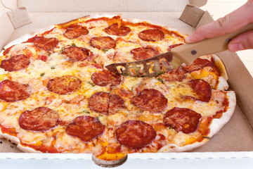 Pizza Pepperoni in a cardboard box. Pizza delivery