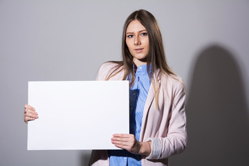 Young woman in a jacket with blank sheet