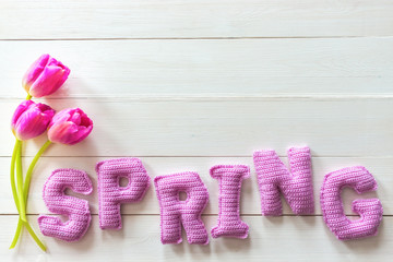 tulip floweres and spring word from knitted letters