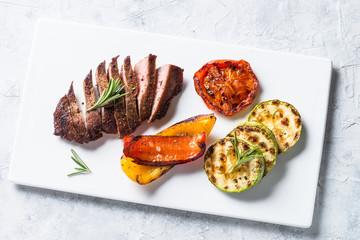 Barbecue dish. Beef steak and grilled vegetables top view.
