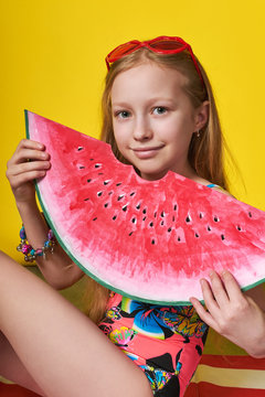 Studio summer portrait young girl looking at camera. Beach Summer Vacation concept. Solar photo teenage woman holding piece red watermelon image. Beautiful, perfect,lovely face child for advertising.